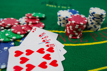 cards, chips lie on the green poker table.