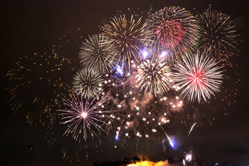 Bright big firework display exploding against a black night sky 