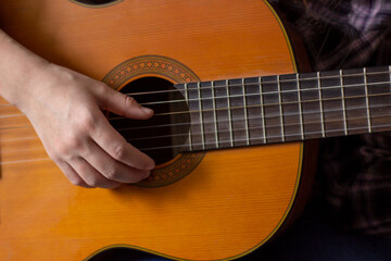 Fototapeta na wymiar person playing acoustic guitar