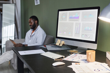Background image of busy home office workplace with computer and person in background, copy space