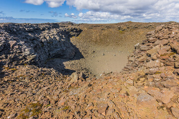 View of a crater of a volcano on Iceland's Reykjanes peninsula. Landscape with brown and gray lava...