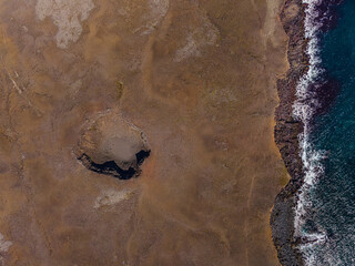 Top view on landscape of Iceland. Extinct crater on brown sand surface on coast of Reykjanes...
