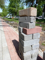 Stack of bricks. Repair of the footpath in the park.