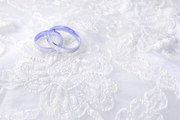 Wedding rings on wedding card on a white background. Trendy Image, Toned in Color of the year 2022,...