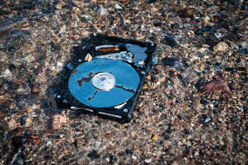 computer rest disk lies in the shallow clear water of the sea