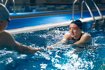 Female actively engaged in swimming in pool
