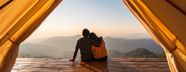 Young couple traveler looking beautiful landscape at sunset and camping on mountain, Adventure...