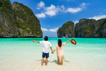 Young couple traveler relaxing and enjoying at beautiful tropical white sand beach at Maya bay in...
