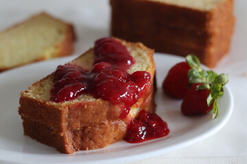 Sour cream pound cake along with a slice of pound cake with strawberry sauce spread.