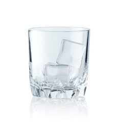 Ice cubes in empty glass on white background. Glass of water or whiskey and wine. Empty glass for alcoholic beverages