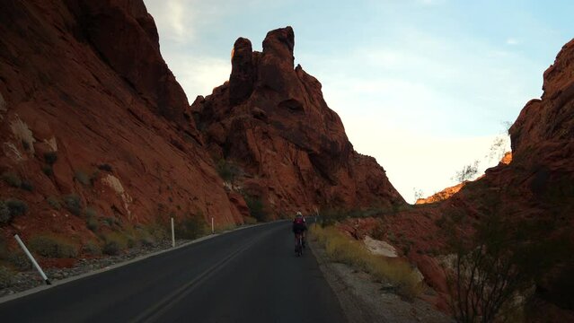Two people biking up a hill