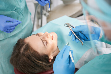 Woman receiving orthodontic treatment in dental clinic
