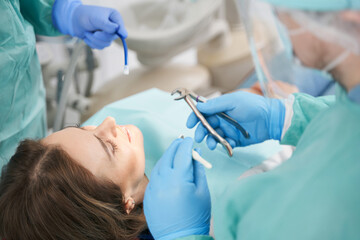 Female patient receiving orthodontic treatment in dental clinic
