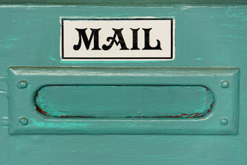 Vintage mail slot and sign in a blue door