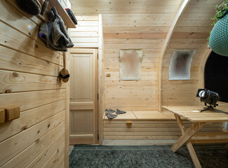 Wooden interior of modern bathhouse. Table and benches.