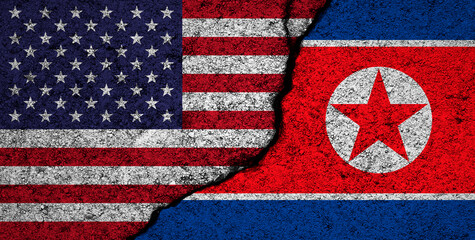 Obraz premium North Korea and USA, America flags background. Cracked wall. Military conflict and war concept photo