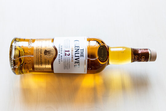 Moscow, Russia - March 20, 2022: lying bottle of 12 years old Glenlivet single malt Scotch whisky on pale table. Glenlivet distillery was founded in 1824 and has operated almost continuously since