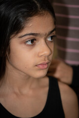 Fototapeta premium A school age Indian ethnicity girl - portrait shots with different facial expressions. 