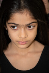 Fototapeta premium A school age Indian ethnicity girl - portrait shots with different facial expressions. 