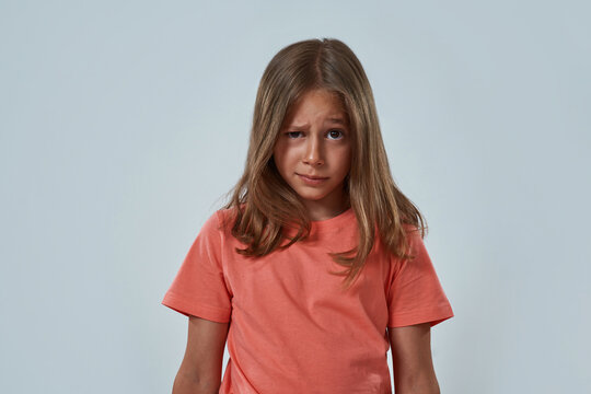 Little girl with skeptical face looking at camera