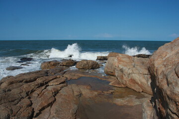 Fototapeta na wymiar Big waves crashing on rocks