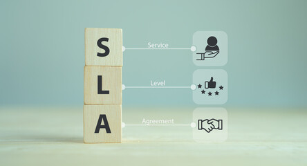 SLA - Service Level Agreement acronym, business concept. Service performance tracking to reduce the uncertainty the customer in process. Wooden cubes with Service Level Agreement icon and abbreviation