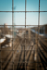 The grid in focus and the railway in defocus, photo in the afternoon