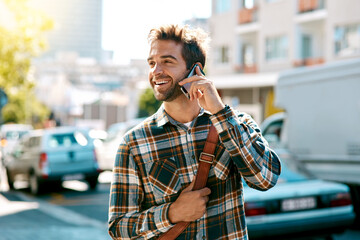 Its where you go and who you know. Shot of a handsome young man using his mobile phone while out in...