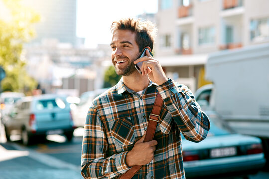 Its where you go and who you know. Shot of a handsome young man using his mobile phone while out in the city.