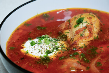 plate of ukrainian borscht with meat and sour cream close-up
