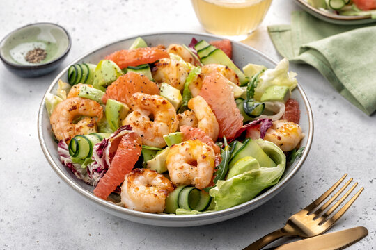 Healthy salad with shrimp prawns, grapefruit, avocado, cucumber and green salad