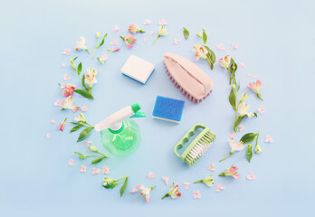 Spring cleaning concept with supplies over pastel blue background. Top view, flat lay - obrazy, fototapety, plakaty