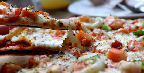 Delicious pizza with seafood on wooden table, italian cuisine,  selective focus.