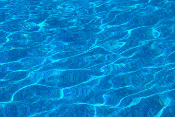 Clear water surface, rippled water in tiled swimming pool