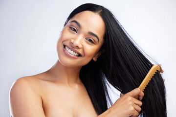 Straight hair and no knots. Shot of an attractive young woman standing alone in the studio and...