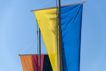 Ukrainian and German flag on the background of blue sky