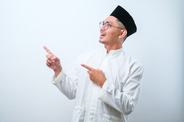 Asian muslim mas pointing something on his side with his both hand