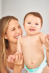 Come on Mom, lets play. Shot of a mother playing with her adorable baby girl.