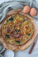 home made quiche with wild garlic on a table