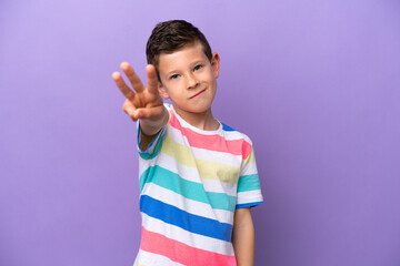 Little boy isolated on purple background happy and counting three with fingers