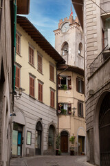 The medieval Italian church is visible in a narrow street, Lovere, Italy
