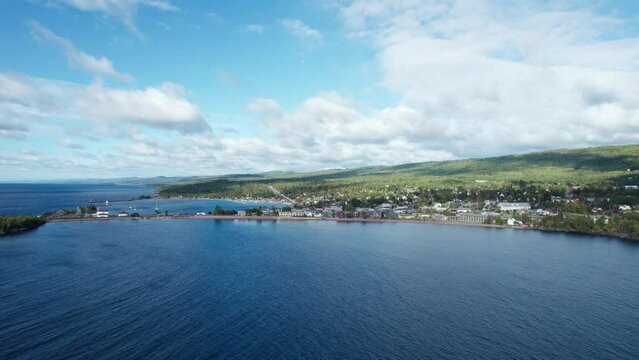 Drone shot over lake superior of Grand Marais on a sunny day in the summer