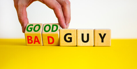 Good or bad guy symbol. Businessman turns cubes and changes concept words Bad guy to Good guy....