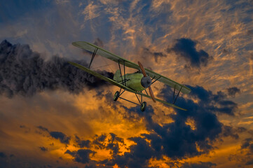Historic vintage biplane propeller with engine on fire and smoke before crash in dramatic sunset...