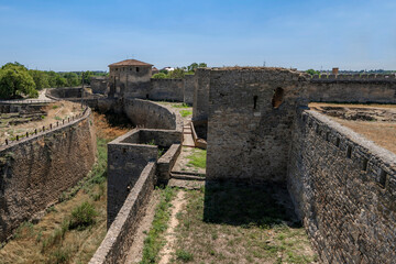 Fototapeta na wymiar Ackerman fortress. Moat and towers of ancient history building. Biggest ukrainian castle. Bilhorod-Dnistrovskyi, Ukraine.