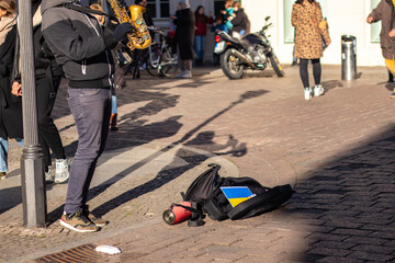 Street musician plays saxophone in support of Ukraine