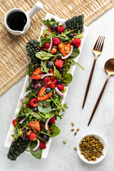A large summer berry salad with toasted pumpkin seeds and balsamic dressing.