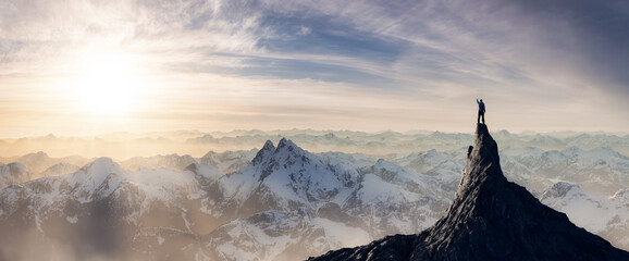 Adventurous Man Hiker standing on top of icy peak with rocky mountains in background. Adventure Composite. 3d Rendering rocks. Aerial Image of landscape from British Columbia, Canada. Sunset Sky - Powered by Adobe