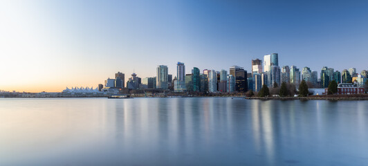 Fototapeta na wymiar Panoramic View of Modern City Building Skyline on West Coast Pacific Ocean. Sunny Winter Sunrise. Stanley Park, Coal Harbour, Downtown Vancouver, British Columbia, Canada.