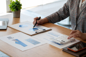 Business accounting woman working in finance and accounting Analyze financial budget in the office.